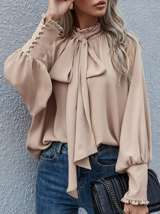 Blusa elegante de mujer con lazo en el cuello