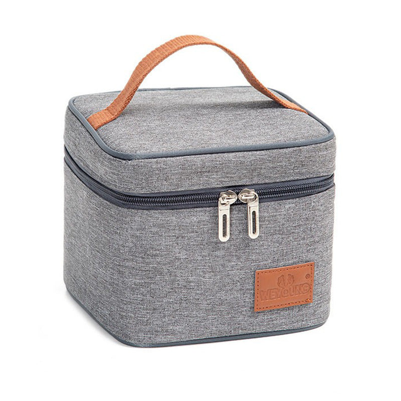 Gray canvas lunch bag with brown handles